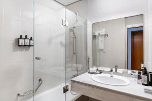 a bathroom with a sink and a shower at Parador de Ceuta in Ceuta
