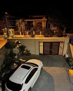 a white car parked in front of a house at Cuchi Downtown in Xóm Bến Cỏ