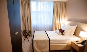 a hotel room with a bed and a window at Hotel Park in Široki Brijeg