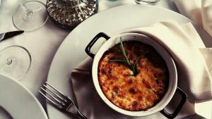 a bowl of food on a white plate on a table at Locanda Al Castelletto in Tremosine Sul Garda +70 photos