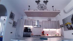a kitchen with a sink and a counter top at P I -G Ó 's HOUSE in Budoni