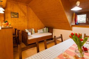 a room with a table and a bench in a cabin at Apartmány Chalupa u Floriánka in Dolní Morava
