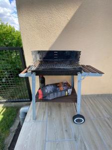a grill sitting on top of a deck at Deák Apartman Gárdony in Gárdony