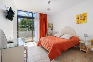 a bedroom with a bed and a large window at Les Malvaux - Chambres d'hôtes in Huriel +51 photos