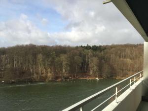 a view of a river from a bridge at App_ an der Seepromenade _ Mittels in Malente