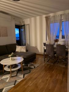 a living room with a couch and a table at Sunset in Teslić