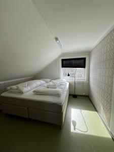 a bedroom with a bed and a window at Charming house close to Lekens in Skullbru +9 photos