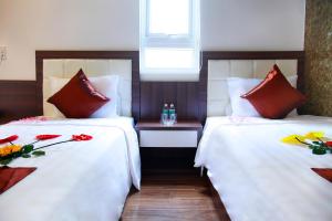 Voodi või voodid majutusasutuse Rich Hotel toas