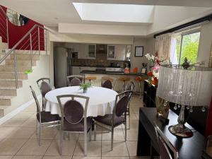 a kitchen and dining room with a table and chairs at Golden Feathers Lodge in Cape Town
