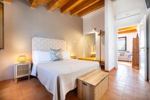 a bedroom with a large bed with a wooden headboard at Terre e Torri Country Resort in Lascari +92 photos