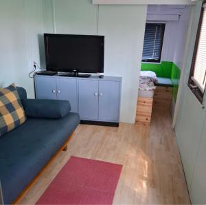 a living room with a couch and a flat screen tv at Casabandow in Schwaan