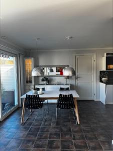 a kitchen with a white table and chairs at Apartment close to Leknes airport in Leknes
