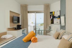 a hotel room with a bed with a view of the ocean at Sandos El Greco - Adults Only in Portinatx