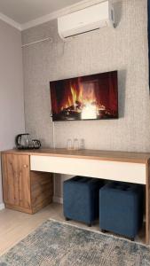 a fireplace in a living room with a fire place at MEIMAN hotel in Aktobe