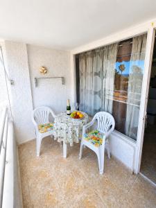 a room with a table and two chairs and a window at 213 Borinquen Holiday in Costa de Adeje