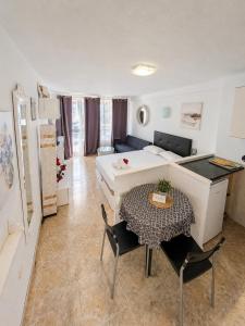 a room with a bed and a table and a bed at 213 Borinquen Holiday in Costa de Adeje