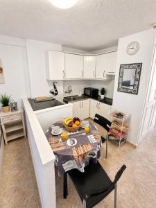 a kitchen with a table with fruit on it at 213 Borinquen Holiday in Costa de Adeje