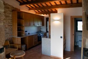 a kitchen with wooden cabinets and a counter top at Natura-Resort Les Pletes in Palouet