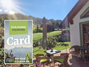 a sign for a garden with a table and chairs at Appartement BERGTRÄUME in Haus im Ennstal