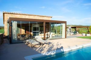 a house with a patio and a swimming pool at Natura-Resort Les Pletes in Palouet