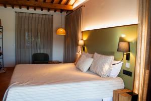a bedroom with a large bed with white sheets and pillows at Natura-Resort Les Pletes in Palouet +37 photos