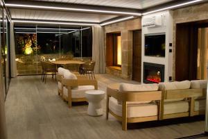 a living room with a fireplace and a table and chairs at Natura-Resort Les Pletes in Palouet