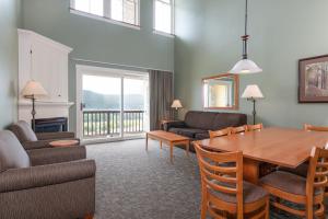 a living room with a table and chairs and a couch at Jackson Gore Village, A Vail Resorts Property in Ludlow