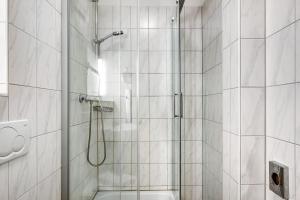 a bathroom with a shower with a glass door at Wohnung direkt an der Skipiste in Feldberg +22 photos