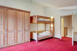 a bedroom with two bunk beds and a mirror at Wohnung direkt an der Skipiste in Feldberg