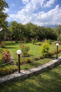 a garden with flowers and lights in a yard at Lidder view Resort - Best River side resort in Pahalgām