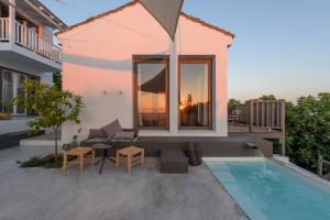 a villa with a swimming pool and a house at Althea Boutique Hotel in Alonnisos