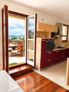 a kitchen with a large sliding glass door leading to a patio at Losinj Panorama Penthouse in Mali Lošinj