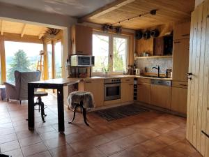 a kitchen with wooden cabinets and a table and a microwave at Ferienhaus Rasselbock in Waltershausen +17 photos