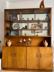 a wooden cabinet with vases on top of it at Pasiphae - Rooms for rent in Agia Galini