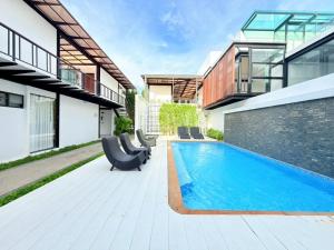 a swimming pool in the backyard of a house at The Gold Living Life in Thung Song