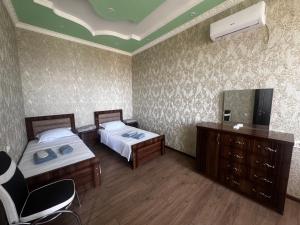 a hotel room with two beds and a mirror at Terrasa Solar Kutaisi in Kutaisi +17 photos