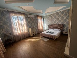 a bedroom with a bed and curtains and a ceiling at Terrasa Solar Kutaisi in Kutaisi