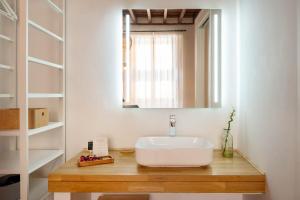 a bathroom with a sink and a mirror at Laguna Cool Living in Las Lagunas +42 photos
