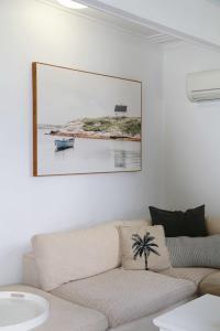 a living room with a couch and a picture on the wall at Summer Breeze Lake House in Forster
