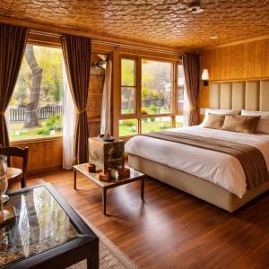 a bedroom with a bed and a large window at River Retreat Resort in Pahalgām