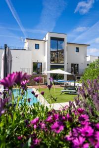 a house with a swimming pool and purple flowers at Casa Dona Edite Guesthouse Douro in Vilarinho de Cotas