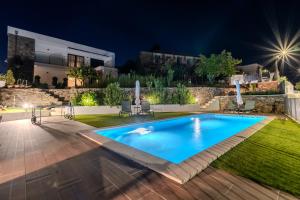 a swimming pool in the yard of a house at night at Casa Dona Edite Guesthouse Douro in Vilarinho de Cotas