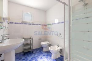 a bathroom with a sink and a toilet and a shower at Palazzo del Borgo Salentino in Acquarica del Capo
