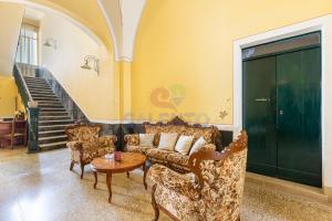 a living room with a couch and chairs and a table at Palazzo del Borgo Salentino in Acquarica del Capo +11 photos