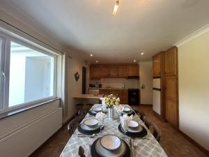 a dining room with a table and a window at Waterside Cottage, Cashel in Galway