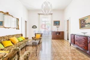 a living room with a couch and a table at Palazzo del Borgo Salentino in Acquarica del Capo
