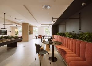a restaurant with a table and chairs and a pool table at Straits Place in Edinburgh in Edinburgh