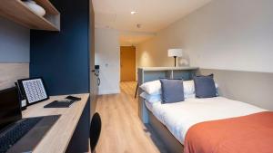 a bedroom with a bed and a desk with a laptop at Straits Place in Edinburgh in Edinburgh +26 photos