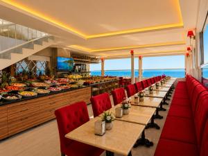 a restaurant with red chairs and a buffet of food at Ayasofya Hotel - Special Class in Istanbul