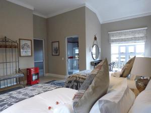 a bedroom with a bed and a living room at Romantic Boutique Cottage in upper Hogsback in Hogsback